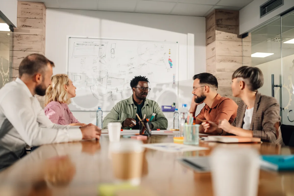 A marketing team around a meeting table working through a campaign plan.